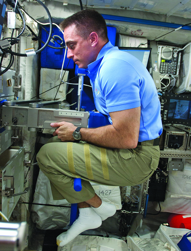 NASA astronaut Chris Cassidy performs body mass measurement activities using the Space Linear Acceleration Mass Measurement Device in the ISS Columbus European Laboratory in April 2013. The device allows crew members to weigh themselves in zero gravity. (Photo courtesy of NASA .)