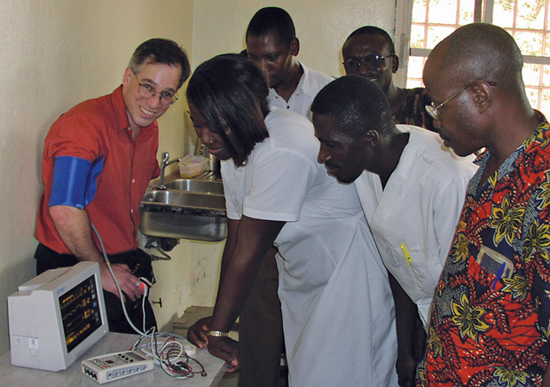 FIGURE 2: Robert Malkin (left) cofounded EWH, which now has chapters on four continents. Here, he visits a group in Sierra Leone. (Photo courtesy of Duke University.)