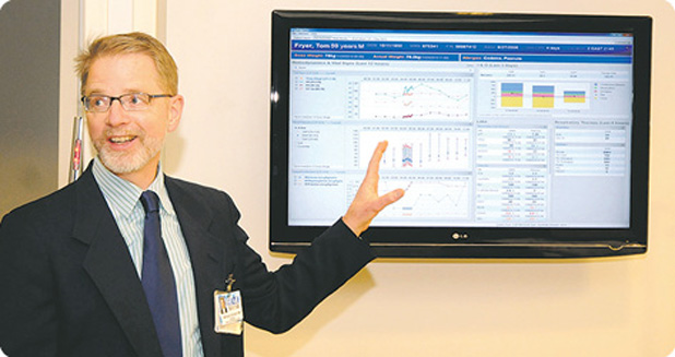 William B. Cornell, M.D., a board-certified pathologist and a member of the Fisher-Titus Medical Center Board of Directors, demonstrates the clinical dashboard, which pulls together relevant information from a patient’s EHR and provides clinicians with an instant customized snapshot. (Photo courtesy of The Norwalk Reflector.)