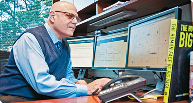 Using software from IBM and Excel Medical Electronics, Emory University Hospital is developing a big-data analytics prototype designed to help clinicians provide predictive care to critically ill patients. Here, Tim Buchman, M.D., Ph.D., the hospital’s director of critical care, uses the prototype. (Photo courtesy of Feature Photo Service for IBM.)