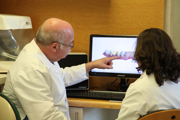 New technology allows dentists to view 3D replicas of the patient’s teeth on the computer screen, and then apply computer-aided design that can ultimately help with the fabrication of a restoration, such as a crown or bridge. Here, Ferencz reviews a CAD design with laboratory technician Marissa Notturno. Photo by Pasquale Fanetti.