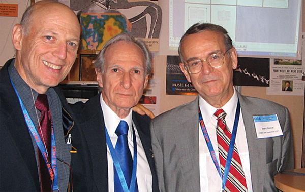 FIGURE 9 - From left: Ron J. Leder (chair), Max E. Valentinuzzi, and Prof. André Dittmar, then members of the IEEE EMBS History Committee, standing at the booth in the exhibit conference room at the 2007 IEEE EMBS Conference.
