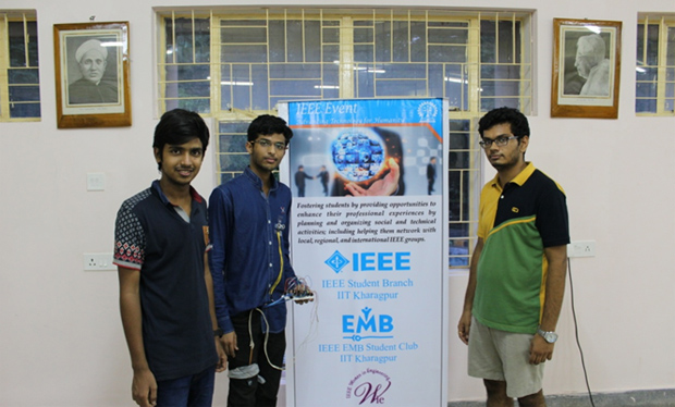 (L-R) Aashay Bhise, Shubh Agrawal and Vraj Parikh with Shubh demonstrating their design.