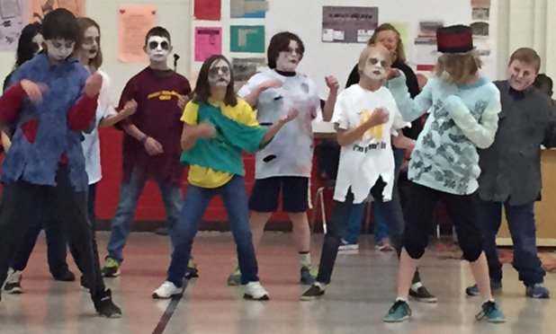Members of Brain Hackers, dressed as zombies, end the production with a “thriller” dance accompanied by student musicians.