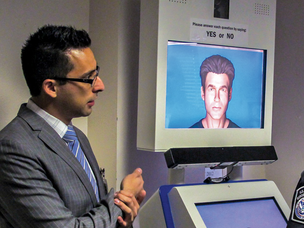 Figure 6: Researcher Aaron Elkins demonstrating an earliergeneration A VATAR, a virtual interviewer used to determine whether someone is lying about having a fake ID. (Photo courtesy of BORDERS.)