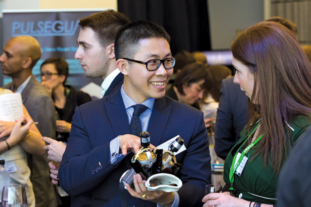 Figure 4: Faii Ong founded a company in London to develop the GyroGlove, which uses gyroscopes to reduce unintended movements associated with tremor. Here, he holds the first prototype. (Photo courtesy of GyroGlove.)