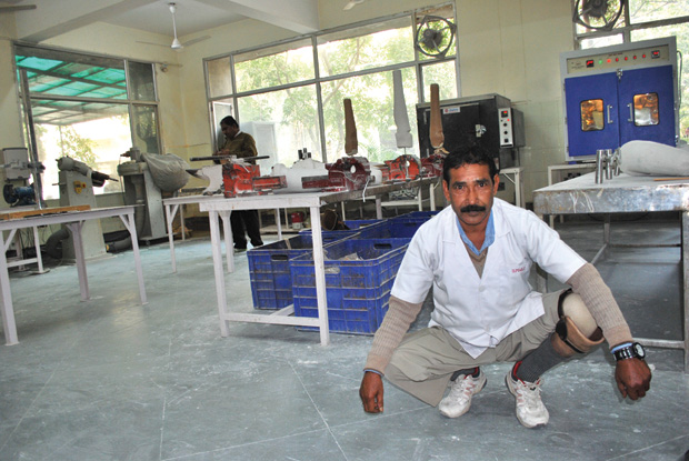 Figure 8: Sudhama Ray, a below-knee amputee, demonstrates squatting with a Jaipur foot. He lost his left leg in a railway accident in 1984 in Kolkata, West Bengal, India, and was fitted with a Jaipur foot in 1988. He now makes artificial legs for others at the BMVSS workshop.