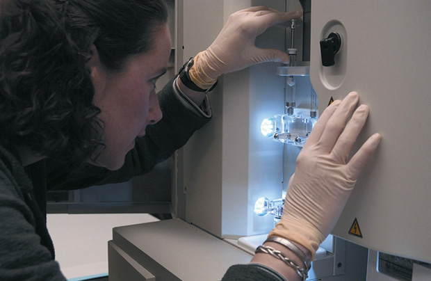 Figure 6: A researcher monitors a DNA sequencing machine in 2010 at Intramural Laboratories, NHGRI, NIH, Bethesda, Maryland. (Photo courtesy of Maggie Bartlett, NHGRI.)