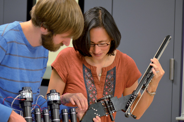 Figure 4: Allison Okamura and colleague Ryder Wink examine a surgical robot arm. (Photo courtesy of Jonathan Edelman.)