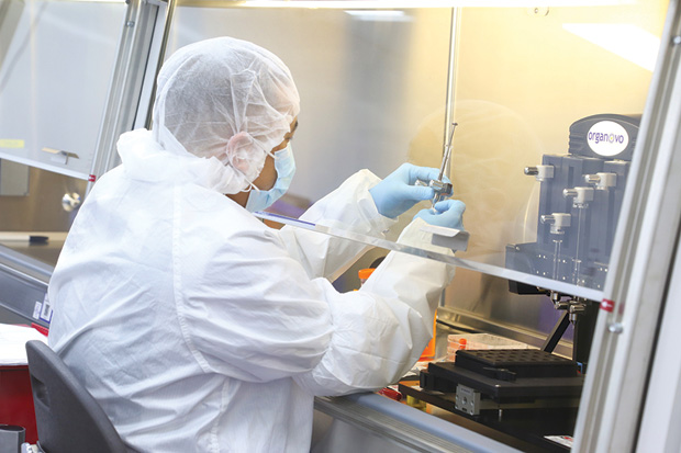 Figure 6: A tissue engineer loads Organovo’s bioprinter with human cell types to generate 3-D tissue. (Photo courtesy of Organovo.)