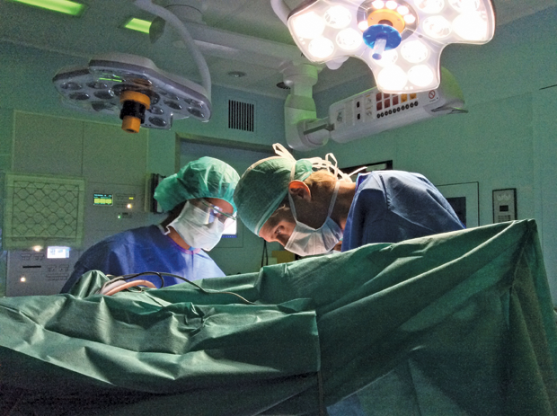 Figure 7: Miller (shown here at right in surgery) hopes to develop implantable devices designed to promote brain plasticity and rehabilitation following brain injury, including stroke and tumor resection. (Photo courtesy of C.J. Kalkman, UMC Utrecht.)