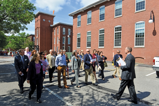 Figure 5: Visitors tour the new ARMI facility in Manchester, New Hampshire, during its dedication ceremonies. The facility occupies one of Manchester’s original red-brick mill buildings. (Photo courtesy of ARMI.)