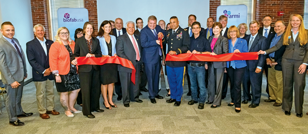 Figure 6: New Hampshire’s governor (with scissors), both New Hampshire senators, and representatives of many of the ARMI partner companies and institutions took part in the ceremonial ribbon cutting this summer at the ARMI headquarters in Manchester. (Photo courtesy of ARMI.)
