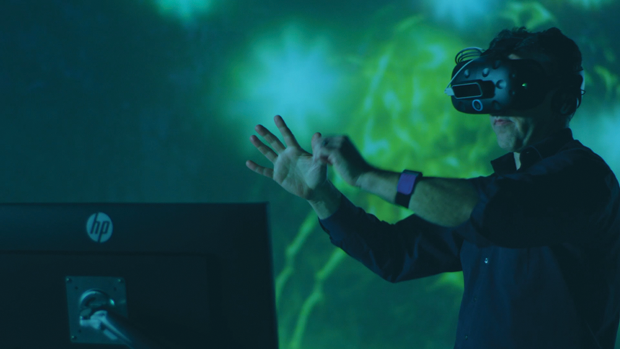 Figure 8. In a VR headset and with hand controllers, Rose explores one of his company’s virtual worlds. (Photo courtesy of Firsthand Technology.)