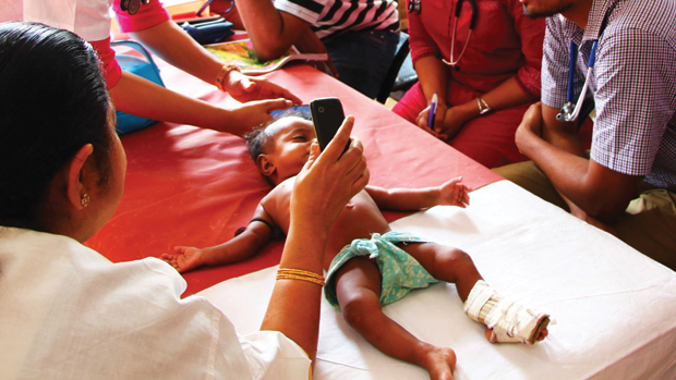 Figure 2. Feebris being used out in the field, on children in Mumbai, India. (Photo courtesy of Feebris.)