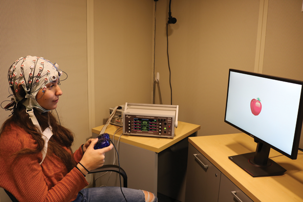 Figure 7. In experiments conducted by Reinhart’s research group, HD-tACS stimulation is applied via the electrodeequipped cap shown, and changes in the subjects’ working memory are evaluated. The researchers showed that personalized HD- tACS improved working memory in older adults. (Photo courtesy of Robert Reinhart.)
