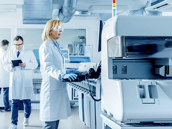 Female scientist programs medical equipment